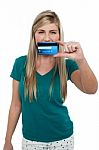 Casual Teenager Holding Up Credit Card Stock Photo