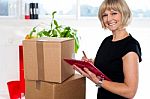 Casual Woman Documenting List Of Goods On Clipboard Stock Photo