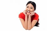 Casual Young Chinese Girl Lying On Studio Floor Stock Photo