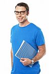 Casual Young Guy Holding Notepad Stock Photo