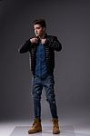 Casual Young Man In Black Leather Jacket And Denim Jeans Stock Photo