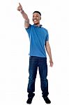 Casual Young Man Pointing Away Stock Photo