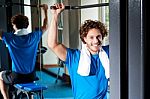 Caucasian Man Sitting On Bench And Exercising Stock Photo