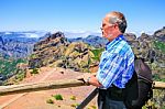 Caucasian Man Viewing Rocky Mountains In Landscape Stock Photo