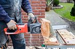 Chain Saw Cutting Wood Stock Photo