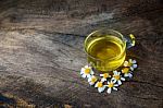 Chamomile Tea And Chamomile Flower On Old Wooden Table Stock Photo