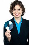 Charming Corporate Lady Holding Data Disc Stock Photo