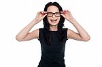 Charming Lady Adjusting Her Eyeglasses Stock Photo