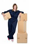 Charming Woman In Uniform Posing With Cartons Stock Photo