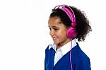 Charming Young Kid Listening To Music Stock Photo