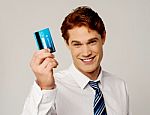 Cheerful Businessman Holding Credit Card Stock Photo