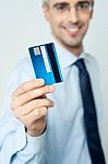 Cheerful Businessman Holding Credit Card Stock Photo