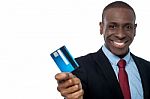 Cheerful Businessman Holding Credit Card Stock Photo