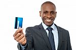 Cheerful Businessman Holding Credit Card Stock Photo