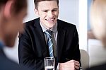 Cheerful Businessman Laughing In Meeting Stock Photo