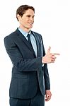 Cheerful Businessman Pointing Away Stock Photo