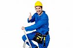 Cheerful Construction Worker On Ladder Stock Photo