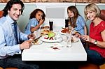 Cheerful Family Enjoying Dinner Stock Photo