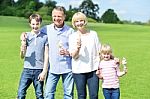 Cheerful Family Holding Yummy Ice Cream Cones Stock Photo