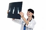 Cheerful Female Doctor Reviewing Patients X-ray Report Stock Photo