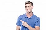 Cheerful Man Pointing His Finger Away Stock Photo