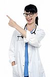 Cheerful Physician Pointing Away, Copy Space Area Stock Photo