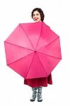 Cheerful Woman Being Playful With Umbrella Stock Photo