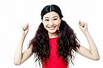 Cheerful Woman With Clenched Fists Stock Photo