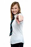 Cheerful Young Girl Pointing Towards The Camera Stock Photo