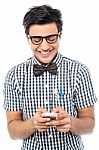 Cheerful Young Man Using Mobile Phone Stock Photo