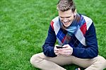 Cheerful Young Relaxed Guy Using Mobile Phone Stock Photo