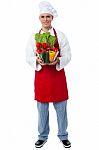 Chef Holding Glass Bowl Full Of Vegetables Stock Photo