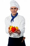 Chef Showing Fresh Capsicums Stock Photo