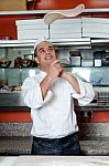 Chef Throwing The Pizza Base Dough Stock Photo