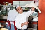 Chef Throwing The Pizza Base Dough Stock Photo