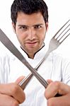 Chef With Cutlery Looking At Camera Stock Photo