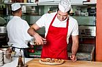 Chefs At Work Inside Restaurant Kitchen Stock Photo