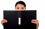 Chinese Woman Hiding Face With Business File Stock Photo