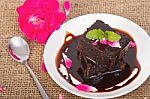 Chocolate Brownie On Plate With Rose Petals Stock Photo