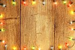 Christmas Light Decorations On Wood Texture Stock Photo