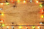 Christmas Light Decorations On Wood Texture Stock Photo