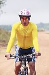 Close Up Face Of Young Man Riding Mountain Bike In Dusty Road Us Stock Photo