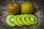 Close Up Fresh Kiwi Fruit On Old Wood Background Stock Photo