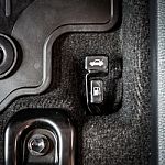 Close Up Hand Switch Of Car Fuel Tank And Hood. Car Interior Stock Photo