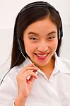 Close-up Of A Smiling Young Woman With Headset Stock Photo