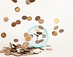 Close Up Of Alarm Clock Stacking Silver Coins Falling Stock Photo