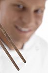 Close Up Of Chopsticks And Chef In Blur Motion Stock Photo