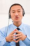 Close-up Of Male Customer Service Representative Wearing Headset Stock Photo