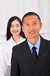 Close-up Of Smiling Businesspeople Stock Photo