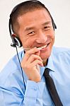 Close-up Of Smiling Male Customer Service Representative Wearing Stock Photo